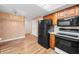Bright kitchen features wood cabinets, modern appliances, and laminate floors at 3875 Offshore Dr, Columbus, IN 47203
