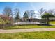A community pool surrounded by trees and a black fence at 3875 Offshore Dr, Columbus, IN 47203