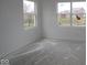 Bright bedroom with white walls, two large windows, and unfinished flooring at 4016 Bozeman Way, Bargersville, IN 46106