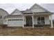 New construction home featuring white siding, brick accents, an attached garage, and covered front porch at 4016 Bozeman Way, Bargersville, IN 46106