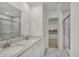 Bright and clean bathroom with double sinks, a marble shower, and a door to the walk-in closet at 4372 Pine Bluff Dr, Bargersville, IN 46106
