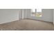 A carpeted bedroom features a bright window and a neutral color palette at 4372 Pine Bluff Dr, Bargersville, IN 46106