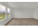 Spacious carpeted room filled with natural light through large windows with outside view at 4372 Pine Bluff Dr, Bargersville, IN 46106
