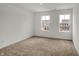 Bright bedroom featuring carpeted floors and natural light from the large double windows at 4372 Pine Bluff Dr, Bargersville, IN 46106