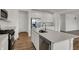 Modern kitchen with stainless steel appliances, island with sink, and white cabinetry at 4372 Pine Bluff Dr, Bargersville, IN 46106