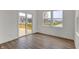 Bright living room with wood floor, sliding door to deck, and large windows overlooking pond at 4372 Pine Bluff Dr, Bargersville, IN 46106