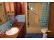 Bathroom features a vanity, sink, toilet, and tub/shower combo at 4478 W County Road 125 S, Greencastle, IN 46135