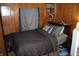 Bedroom with wood paneling and a made bed at 4478 W County Road 125 S, Greencastle, IN 46135