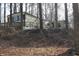 Exterior view of a manufactured home in a wooded area with a deck at 4478 W County Road 125 S, Greencastle, IN 46135