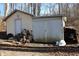 Exterior view of the outbuilding, showing its construction, door, and general condition at 4478 W County Road 125 S, Greencastle, IN 46135