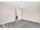 This bedroom features neutral walls, gray carpeting, a doorway leading to another room, and white trim around the door at 4777 E Summerfield Dr, Camby, IN 46113