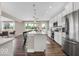 Open concept kitchen with stainless steel appliances, island with seating, and wood flooring at 4777 E Summerfield Dr, Camby, IN 46113