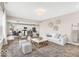 Open-concept living room with modern decor, seamless flow to the kitchen, and comfortable seating at 4777 E Summerfield Dr, Camby, IN 46113