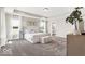 This spacious main bedroom includes neutral decor, tray ceiling, and lots of natural light at 4777 E Summerfield Dr, Camby, IN 46113