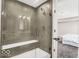 Modern tile shower featuring a glass door and shower bench at 4777 E Summerfield Dr, Camby, IN 46113