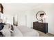 Bright bedroom featuring a dresser with round mirror and neutral decor at 5035 Astor Ct, McCordsville, IN 46055