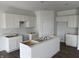 Spacious kitchen featuring white cabinets, a center island, and hardwood floors at 5210 Cartland Dr, Indianapolis, IN 46239