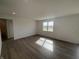 Spacious living room featuring hardwood floors and a large window at 5210 Cartland Dr, Indianapolis, IN 46239