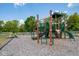Community playground featuring a slide, climbing structures, and a swing set at 5210 Cartland Dr, Indianapolis, IN 46239