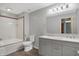 Bathroom with grey walls, a double vanity sink, and a shower tub combination at 5371 Lue Ann Ln, Mooresville, IN 46158