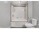 Bathroom with white tile shower tub and white toilet at 5371 Lue Ann Ln, Mooresville, IN 46158
