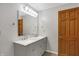 Bathroom featuring a double sink vanity with a large mirror and ample lighting at 5371 Lue Ann Ln, Mooresville, IN 46158
