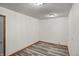 A room with light gray laminate flooring, white walls and a ceiling light at 5371 Lue Ann Ln, Mooresville, IN 46158
