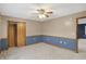 Bedroom with neutral carpet, wainscotting, a ceiling fan and an open door at 5371 Lue Ann Ln, Mooresville, IN 46158