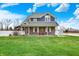 Charming two-story home featuring a covered porch and a well-maintained lawn at 5371 Lue Ann Ln, Mooresville, IN 46158
