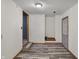 A hallway featuring gray laminate flooring, white walls and access to the exterior at 5371 Lue Ann Ln, Mooresville, IN 46158