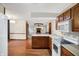 Kitchen showcasing wood cabinets with view to the Gathering room and fireplace at 5371 Lue Ann Ln, Mooresville, IN 46158