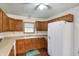 A kitchen with wood cabinets, light countertops, and white appliances at 5371 Lue Ann Ln, Mooresville, IN 46158