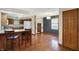 Modern kitchen with breakfast bar, wooden cabinets, hardwood floors, and ample lighting, creating a functional and stylish cooking space at 5371 Lue Ann Ln, Mooresville, IN 46158