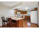 This kitchen features wood cabinets, laminate countertops and bar stool seating at 5371 Lue Ann Ln, Mooresville, IN 46158