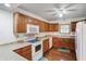 This kitchen features wood cabinets, laminate countertops, and white appliances at 5371 Lue Ann Ln, Mooresville, IN 46158