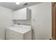 A laundry room with a white washer and dryer, white cabinets, and a towel rack at 5371 Lue Ann Ln, Mooresville, IN 46158