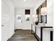 Bright entryway featuring wood-look floors, console table, and a front door with glass panel at 5803 Sunstone Rd, Indianapolis, IN 46239