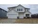 Charming two-story home with a two-car garage, white siding, and beautiful architectural details at 5803 Sunstone Rd, Indianapolis, IN 46239