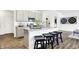 Open kitchen with stainless steel appliances, gray cabinets, a center island, and wood-look floors at 5803 Sunstone Rd, Indianapolis, IN 46239