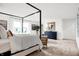 Bright main bedroom with a four-poster bed, sitting area, and dresser for ample storage at 5803 Sunstone Rd, Indianapolis, IN 46239