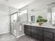 Modern bathroom features a double vanity, a glass-enclosed shower, and contemporary fixtures at 5832 Lyster Ln, Indianapolis, IN 46239