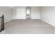 Large, carpeted bonus room area with access to additional rooms and a storage closet at 5832 Lyster Ln, Indianapolis, IN 46239