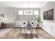 Bright dining area featuring table with seating, modern chandelier, and a decorative houseplant at 5832 Lyster Ln, Indianapolis, IN 46239