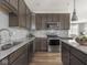 Contemporary kitchen with stainless appliances, a granite countertop, and ample natural light at 5832 Lyster Ln, Indianapolis, IN 46239