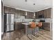 Modern kitchen featuring stainless steel appliances, dark wood cabinets, a tile backsplash, and bar seating at 5832 Lyster Ln, Indianapolis, IN 46239