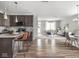 Open-concept kitchen and living area with modern finishes, stainless steel appliances, and stylish furniture at 5832 Lyster Ln, Indianapolis, IN 46239