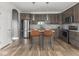 Modern kitchen features stainless steel appliances, granite countertops, and stylish island with seating at 5832 Lyster Ln, Indianapolis, IN 46239