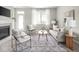 Cozy living room showcasing comfortable seating, a natural view, and a decorative rug at 5832 Lyster Ln, Indianapolis, IN 46239