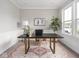 Bright office space with a large desk, stylish decor, and a large window for natural light at 5832 Lyster Ln, Indianapolis, IN 46239