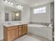 Bathroom featuring double sink vanity, tub, and natural light at 6075 Meadowview Dr, Whitestown, IN 46075